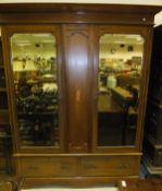 An Edwardian mahogany barber pole strung wardrobe, the moulded cornice over a pair of shaped