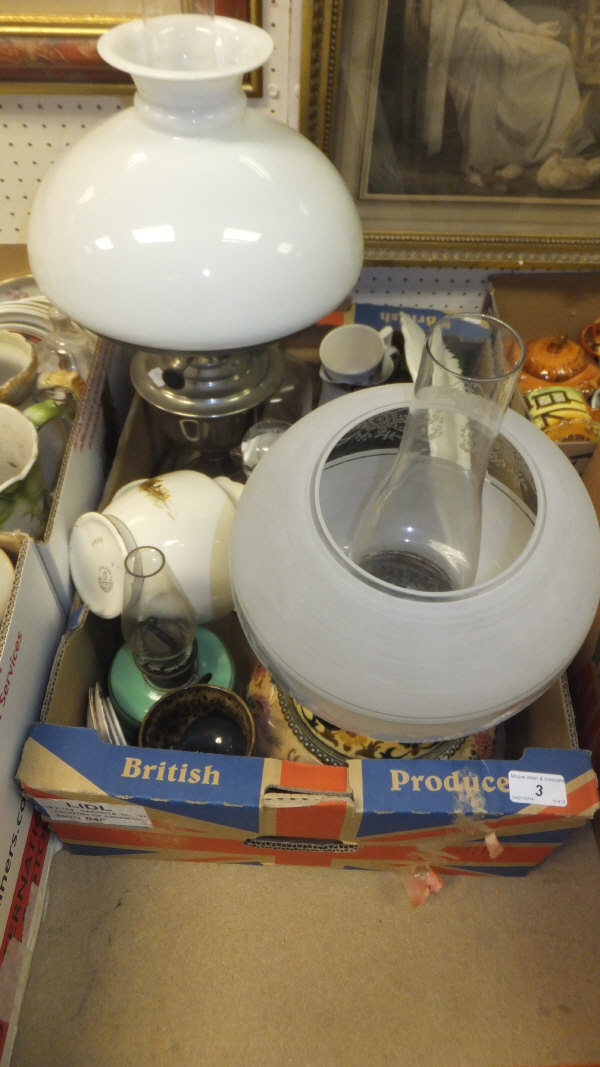 A box of assorted sundry items to include a pair of Dartington glass decanters, two oil lamps, etc