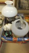 A box of assorted sundry items to include a pair of Dartington glass decanters, two oil lamps, etc