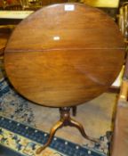 An early 19th Century mahogany occasional table, the circular snap top on baluster turned and ringed