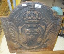 A cast iron fire back with crest decoration