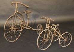 A circa 1900 20" tricycle with a metal frame, together with one smaller tricycle