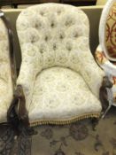 A Victorian buttoned upholstered salon arm chair with moulded rosewood showframe arms on turned