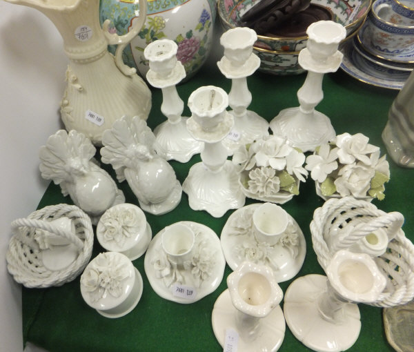 A collection of blanc-de-chine wares to include a Belleek ewer, floral ornaments, candlesticks,