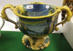 A Cantigalli style majolica three handled bowl raised on circular foot, with Cupid and Classical