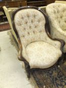 A Victorian walnut framed button back salon armchair
