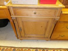 A 19th Century Continental pine side cabinet with single drawer above cupboard door