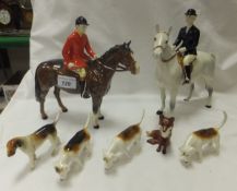 A Beswick pottery figure of a huntsman together with a Beswick pottery figure of a huntswoman, three