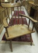 A 19th century primitive Welsh beech and elm chair with curved crested rail and five spindle back to