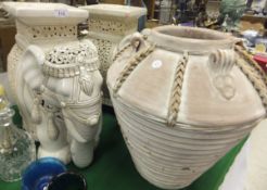 A pair of white glazed stoneware elephant seats with elaborate howdah and an alabaster urn of neo-