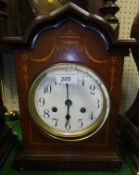 An Edwardian mahogany and inlaid mantel clock, the eight day movement with circular dial and