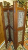 An Eastern hardwood three fold dressing screen, each side inset with richly painted panels in the