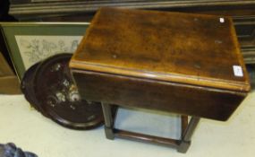 A yew wood  drop-leaf occasional table with stretchered base