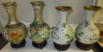 Two pairs of 20th century Chinese cloisonné vases, each decorated with flowers, on hardwood bases