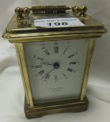 A brass mounted carriage clock with Roman numerals, the dial with date, marked Bornand Freres