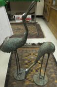 A pair of Chinese bronze models of cranes, each on circular base, unsigned