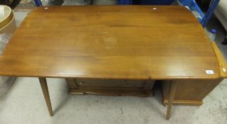 A small Ercol dining table, the shaped rectangular top raised on splayed legs   CONDITION REPORTS