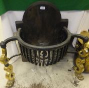 A cast iron fire basket and back with scrolled brass front legs to paw feet