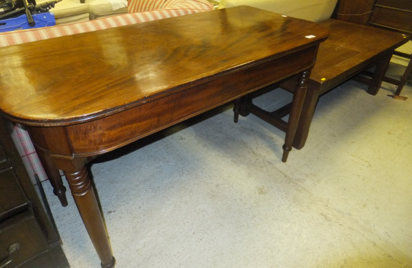 A 19th Century mahogany rounded rectangular dining table end section on turned tapering legs and a