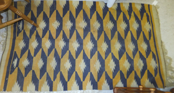 A tribal Kelim, the red, yellow and blue striped design on a blue ground, 189 cm x 106 cm,