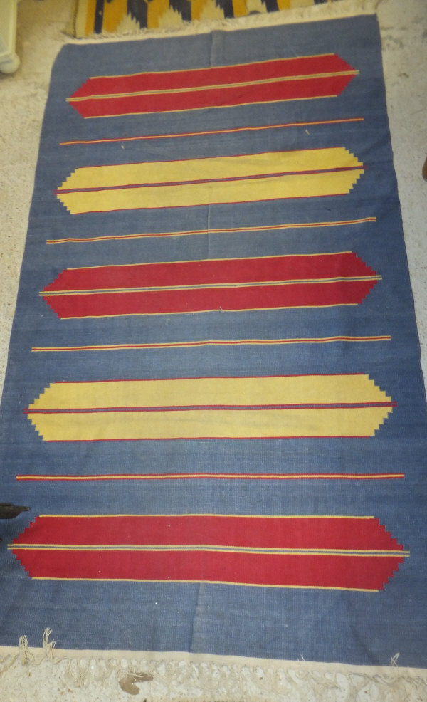 A tribal Kelim, the red, yellow and blue striped design on a blue ground, 189 cm x 106 cm, - Image 2 of 2