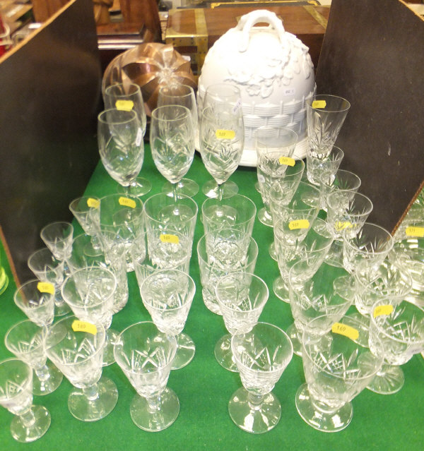 A collection of various cut glass pedestal drinking glasses, tumblers, wines, copper jelly mould and