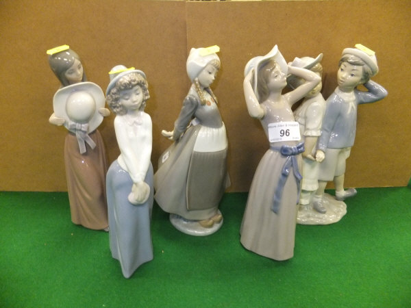 A collection of four Lladro figures to include "Girl wearing wide-brimmed hat", "Girl holding wide-