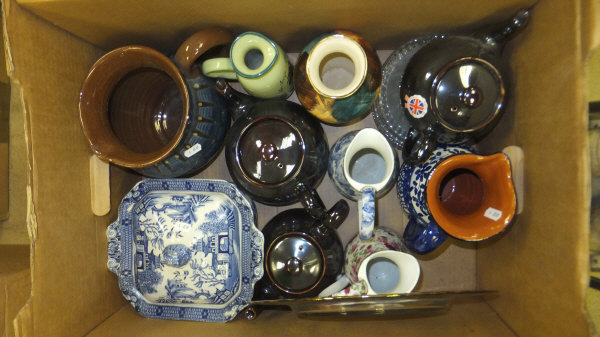 A box containing assorted jugs, teapots, Willow pattern tureen, etc