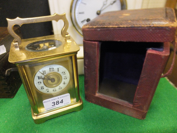 A circa 1900 French lacquered brass cased carriage clock, the circular dial with Arabic numerals,