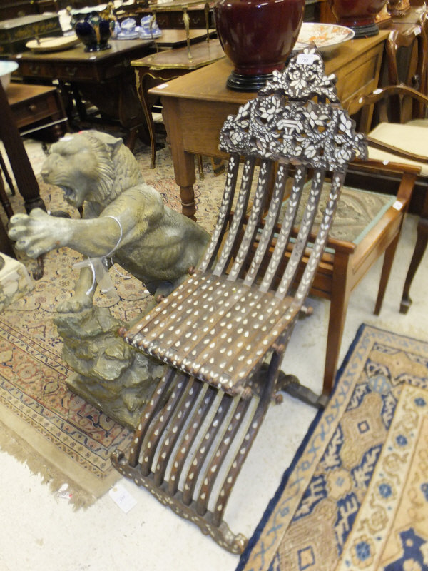 A Moroccan hardwood and inlaid folding X-frame chair