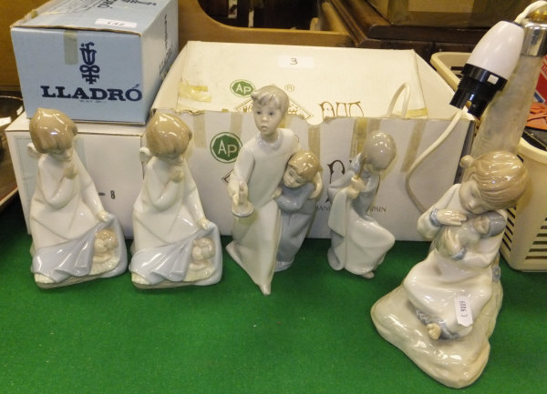 A collection of five Lladro and Nao figures to include a Nao table lamp base, two Lladro figures