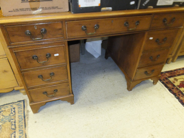 A modern reproduction yew wood veneered double pedestal desk