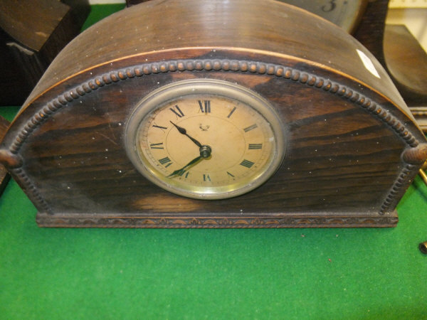 A late 19th Century walnut cased mantel clock and two early 20th Century oak cased mantel clocks