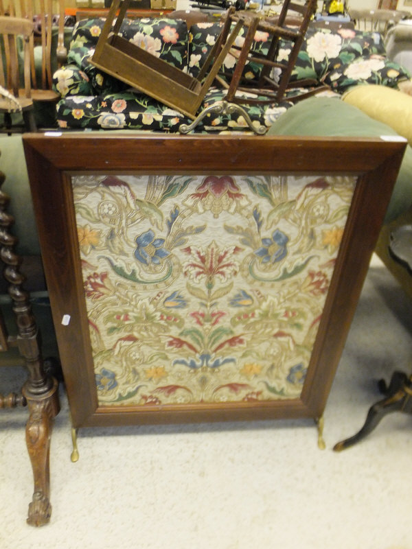 A stained pine framed firescreen with central foliate embroidered panel