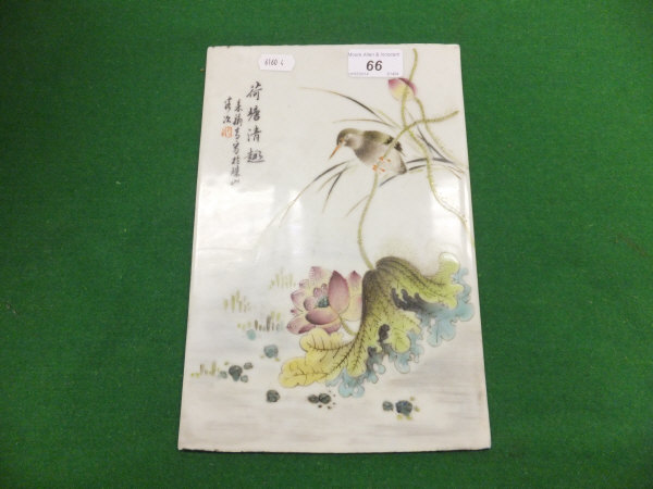A Chinese porcelain tile / plaque painted with a bird on a water lily stalk, and bearing character