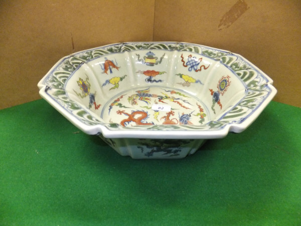 A large Chinese porcelain bowl of hexagonal form decorated in the famille-vert palette with dragon