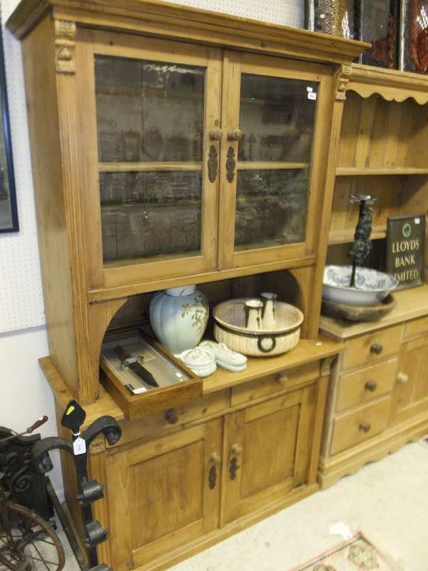 A Continental pine dresser with two glazed doors over drawers and cupboard doors