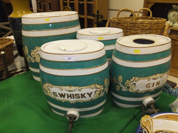 A large pottery spirit barrel inscribed "Gin" with metal tap, together with three further matching