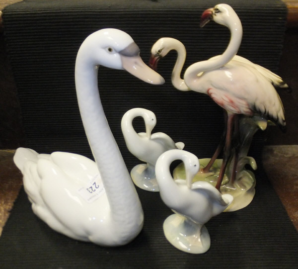 A Lladro swan figure, two Lladro goose figures and a Keramos flamingo figure group