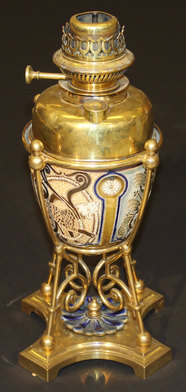 A Doulton Lambeth oil lamp base by Mark V Marshall in brass frame to quatrefoil base, with