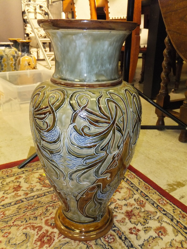 A Royal Doulton baluster shaped vase with tube-lined scrolling foliate and floral decoration by