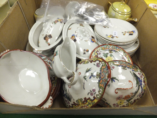 A box containing children's pottery dinner wares, together with miniature knives, forks and spoons