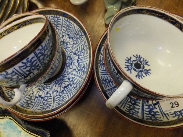 A set of four 18th century Caughley lily pattern cups and saucers with gilt decorated borders (circa