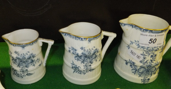 A graduated set of three Royal Worcester china jugs, relief moulded as coopered barrels and with