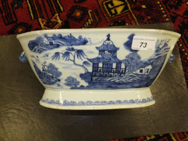 A Chinese Ch'ien Lung rounded rectangular tureen, decorated with pagoda by a lake, flanked by