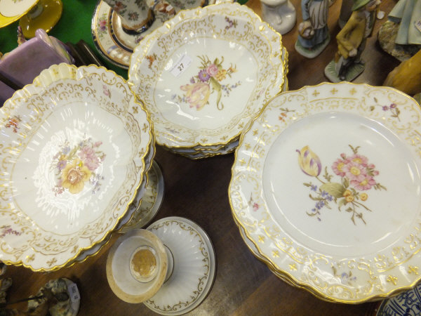 An early 20th century Continental dessert service with floral decoration comprising ten plates, four