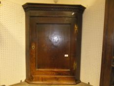 An 18th Century oak hanging corner cupboard