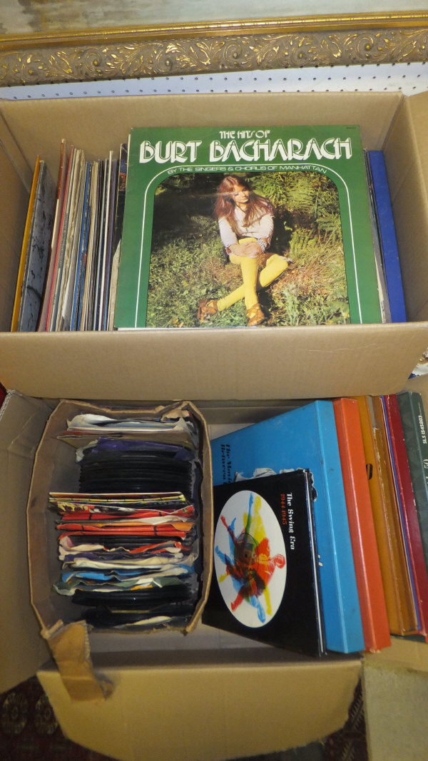 Two boxes of assorted LP's and 45's to include The Bee Gees, Burt Bacharach, Glen Campbell, Elton