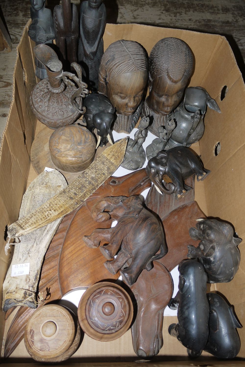 A quantity of late 20th century African carvings including elephants, busts, figures, birds, two