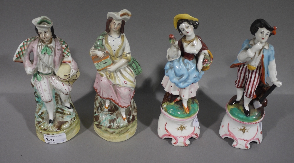 A pair of Staffordshire figures of a Scottish drummer and companion, together with a pair of